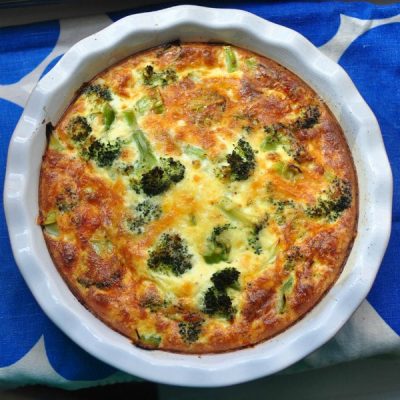 Broccoli and other vegetables quiche baked in a ceramic bowl.