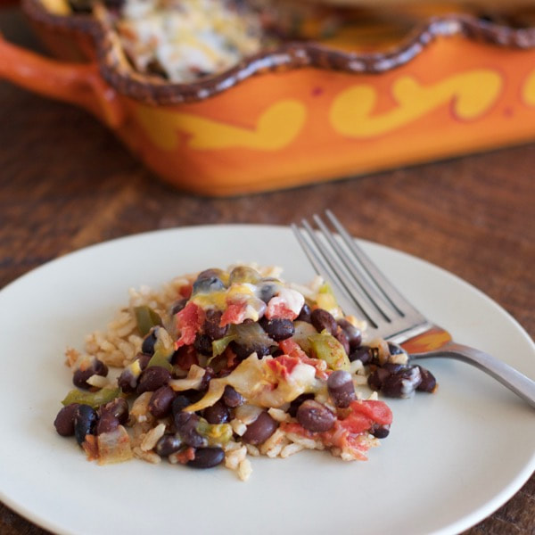 Plate of bean, rice, and colorful vegetables baked in oven.