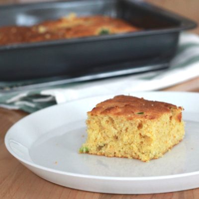 Slice of corn bread with chopped jalapeno cooked in it.
