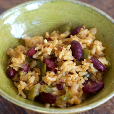 Bowl of mixed rice with beans, celery, bell peppers, garlic, and onion