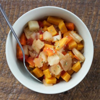 Bowl of cubed potatoes, onions, sweet potato, parsnip, carrots, and diced tomatoes, cooked in vegetable broth