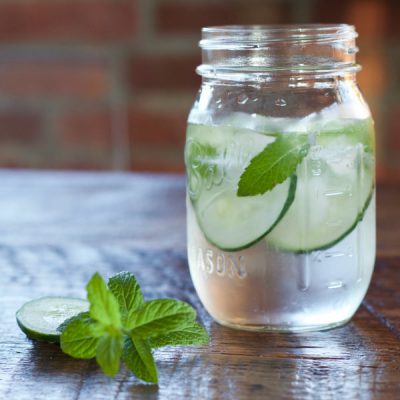 Mason jar filled with mint and cucumber infused water