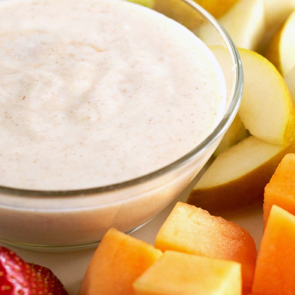 Bowl of fruit dip made with vanilla yogurt, orange juice, and lime juice.