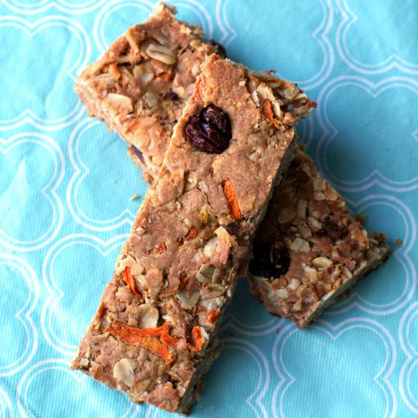 Homemade granola bars made of honey, peanut butter, oats, raisins, carrots, and coconut.