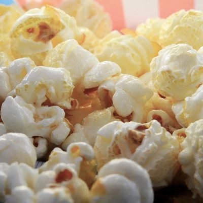 Close up of white and yellow kettle corn in a colored bowl