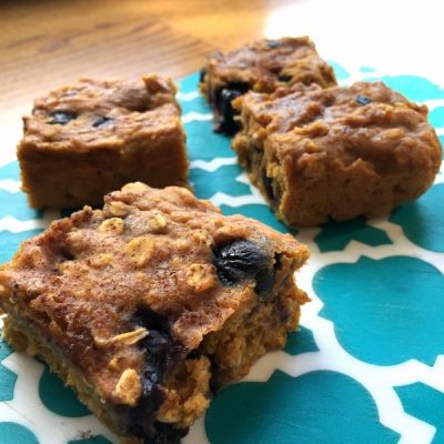 Squares of cooked sweet potato, blueberry, and oats.