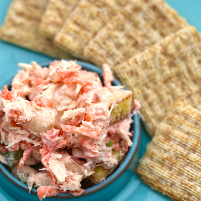 Bowl of tuna, slightly pinkened with grated carrot, pear and celery mixed in plain yogurt.