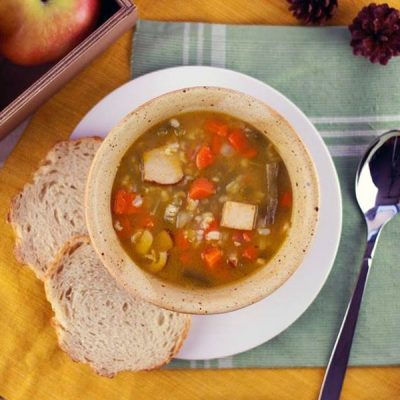 Bowl of chopped turkey, carrots, and celery in chicken broth.