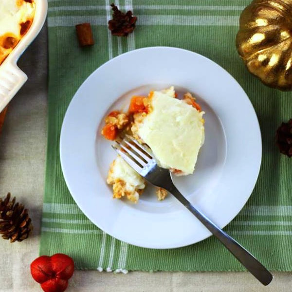 Plate of shepherd's pie including ground turkey, onions, tomatoes topped with mashed potatoes.