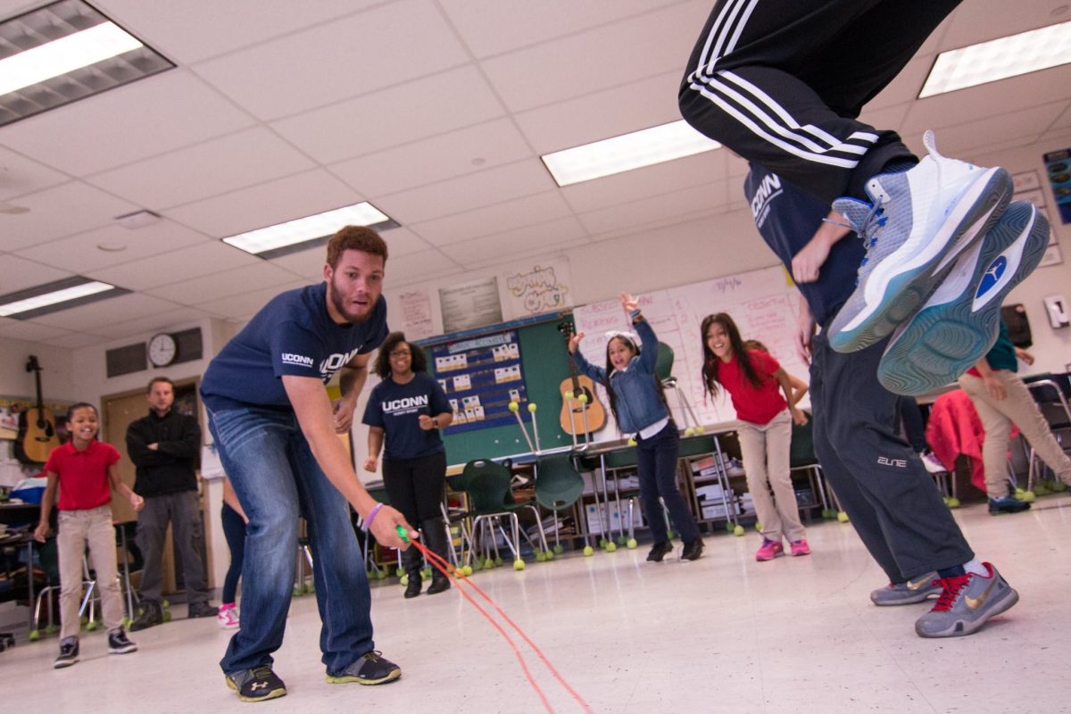 Image of kids in a classroom playing jump rope.