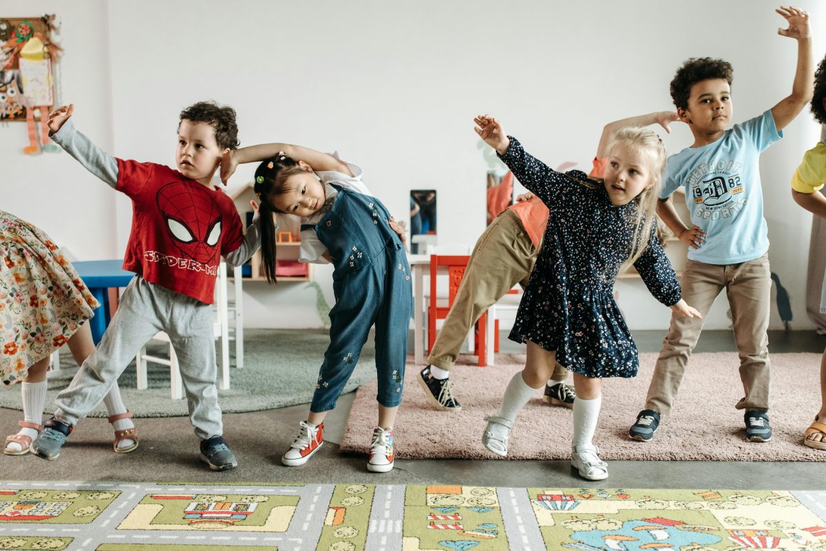 Younger children exercising in a classroom.